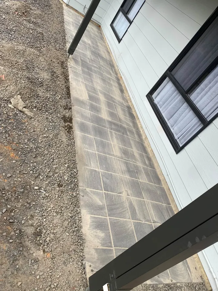 A finished paved side path with gravel along the edge
